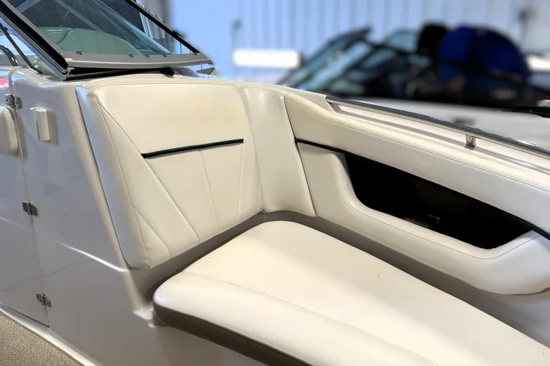Slide: The Image of 2008 Four Winns H240 boat interior with white leather seating and sleek design. - 8