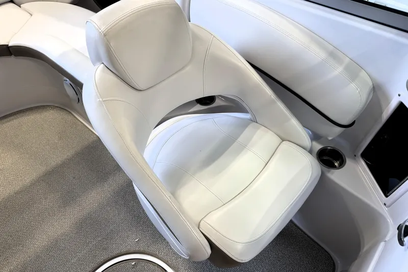 Slide: The Image of White leather seating in a 2008 Four Winns H240 boat interior. - 16
