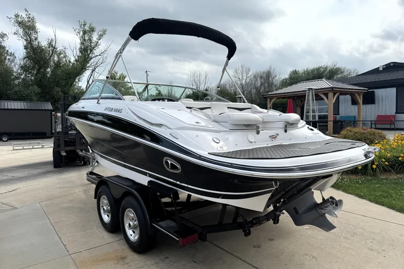 Slide: The Image of 2008 Four Winns H240 boat on trailer, parked outdoors with overcast sky. - 3