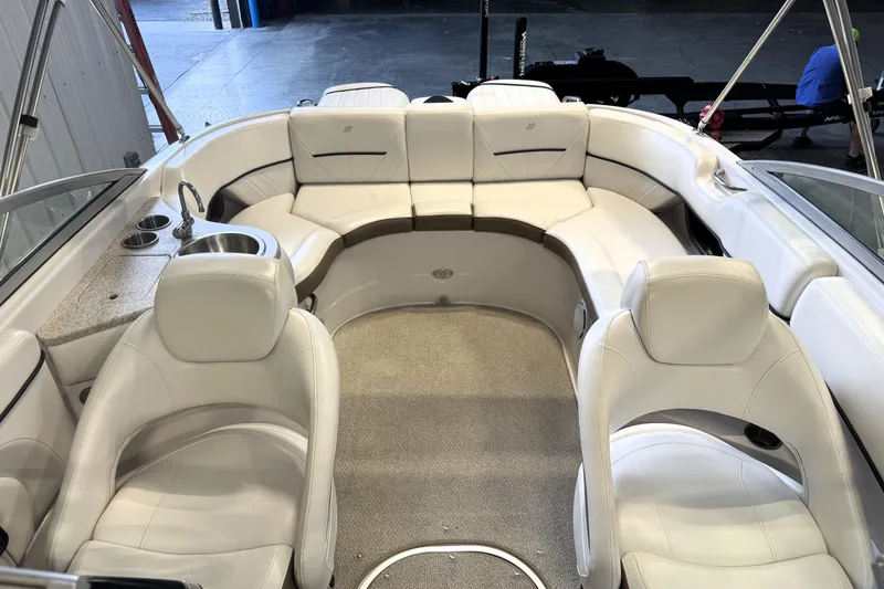 Slide: The Image of Luxurious interior of 2008 Four Winns H240 boat with white seating and built-in amenities. - 9
