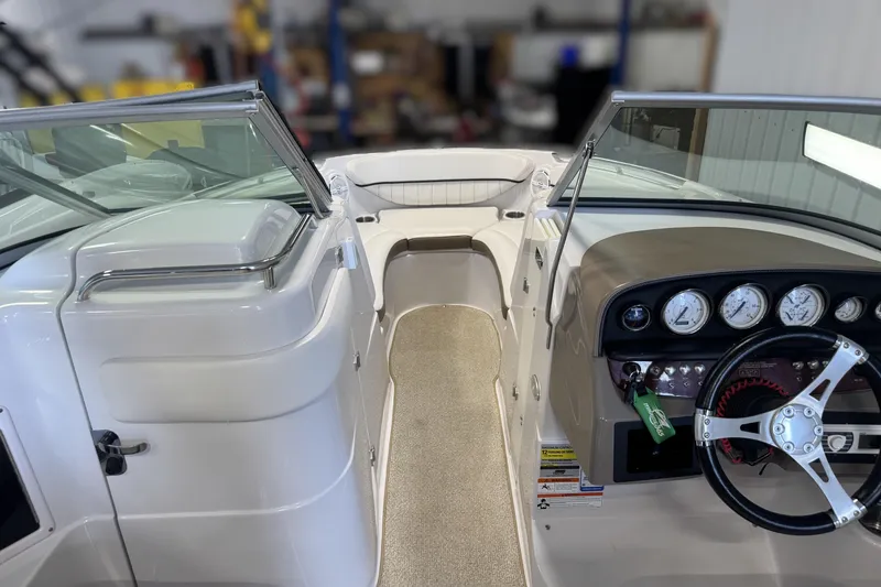 Slide: The Image of 2008 Four Winns H240 boat interior with steering wheel and dashboard gauges. - 29