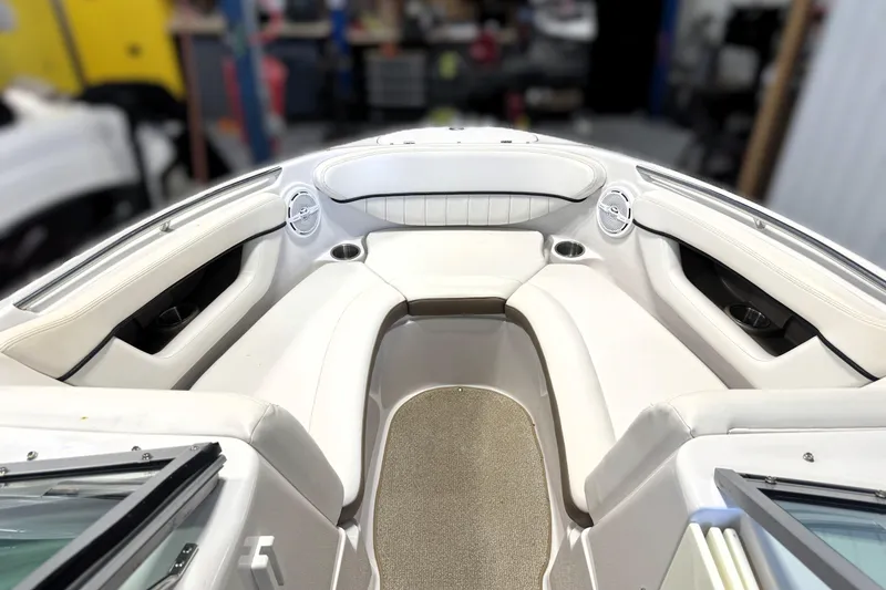 Slide: The Image of Interior view of a 2008 Four Winns H240 boat, featuring white seating and cup holders. - 34