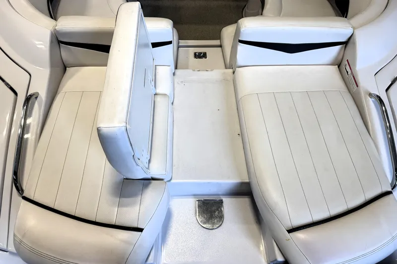 Slide: The Image of 2008 Four Winns H240 boat interior with white seating and chrome accents. - 25