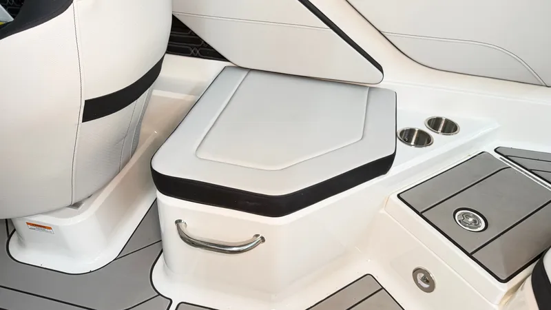 Slide: The Image of The 2026 Sea Ray SPX 210 features a sleek seat with integrated storage and cup holders. - 27