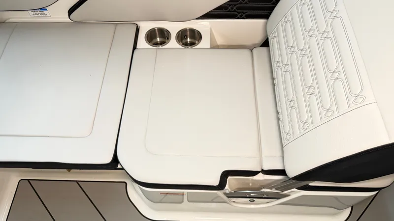 Slide: The Image of The 2026 Sea Ray SPX 210 features stylish white upholstery with two cup holders. - 25