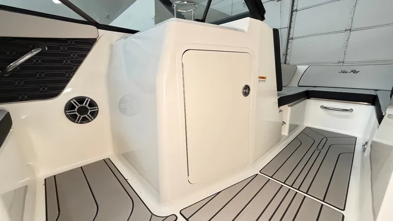 Slide: The Image of Interior of a 2026 Sea Ray SPX 210 with gray flooring and white walls. - 44