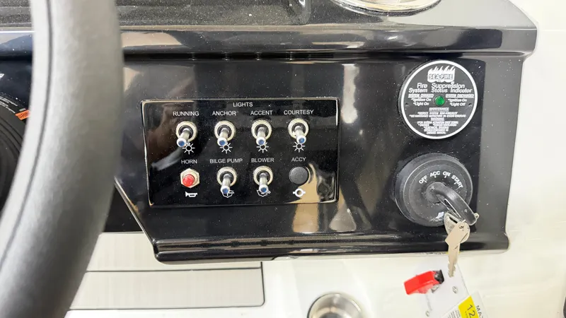 Slide: The Image of Dashboard of a Sea Ray SPX 210 with switches and ignition key. - 39