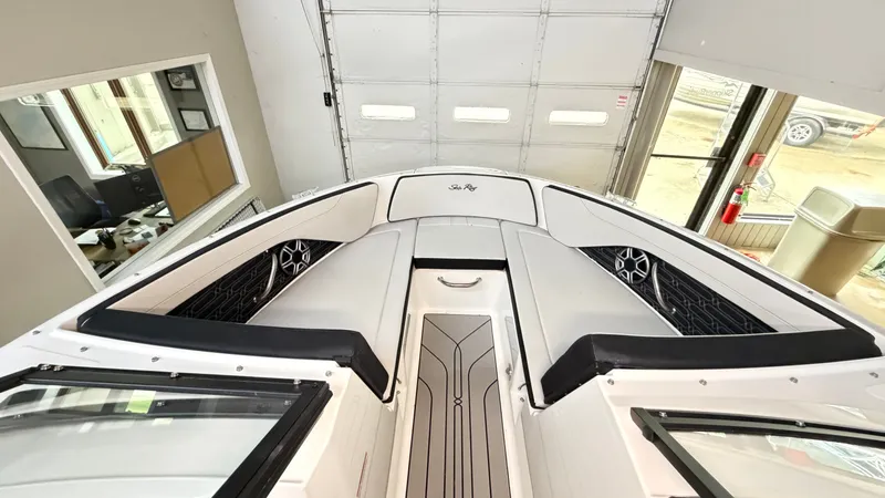Slide: The Image of Interior view of a Sea Ray SPX 210 boat with white upholstery and black accents. - 48