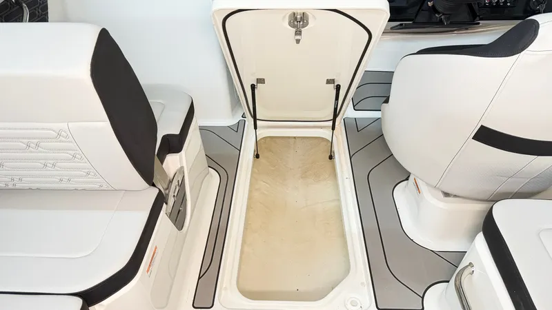 Slide: The Image of The image shows the interior of a Sea Ray SPX 210 boat with an open storage compartment. - 30