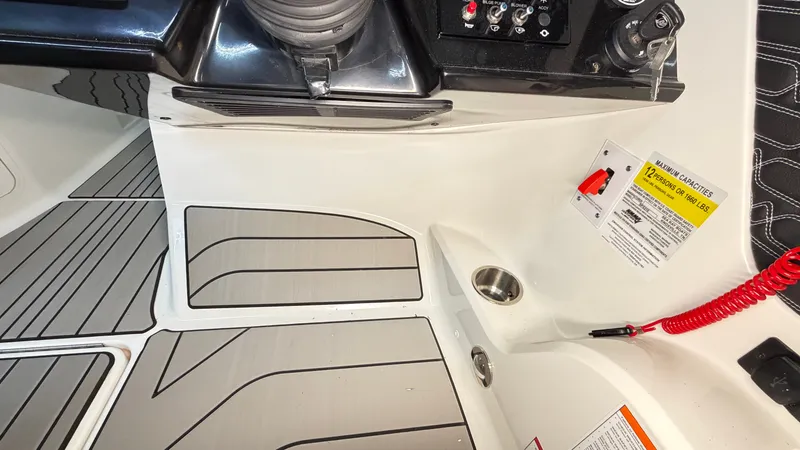 Slide: The Image of Close-up of a Sea Ray SPX 210 boat's cockpit area with controls and flooring. - 43