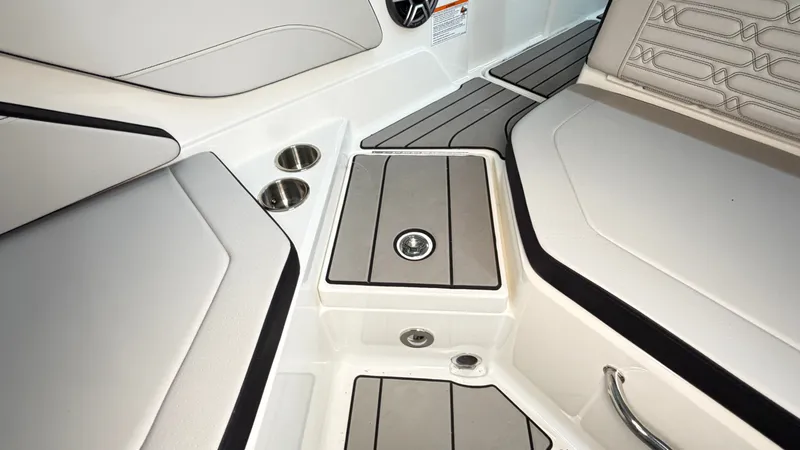 Slide: The Image of The image shows the interior of a Sea Ray SPX 210 boat with sleek seating and cup holders. - 21