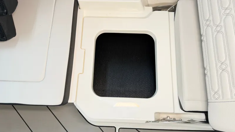 Slide: The Image of An open storage compartment on a 2026 Sea Ray SPX 210 boat. - 26