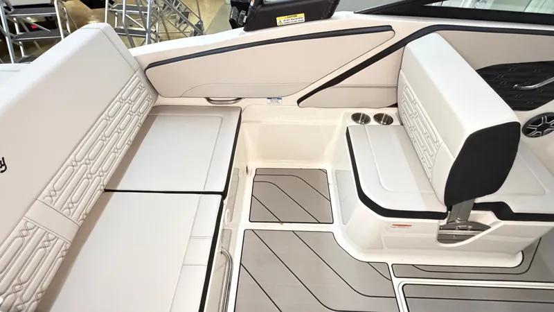 Slide: The Image of Interior of a Sea Ray SPX 210 boat with sleek white seating and gray flooring. - 23
