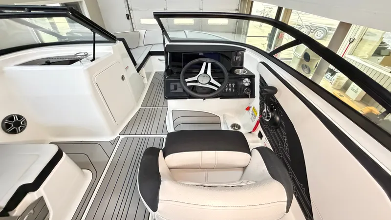 Slide: The Image of The image shows the cockpit of a Sea Ray SPX 210 boat with a modern helm and seating. - 36
