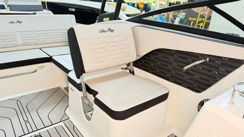 Slide: The Image of The image shows the interior of a Sea Ray SPX 210 boat with sleek white seating. - 31