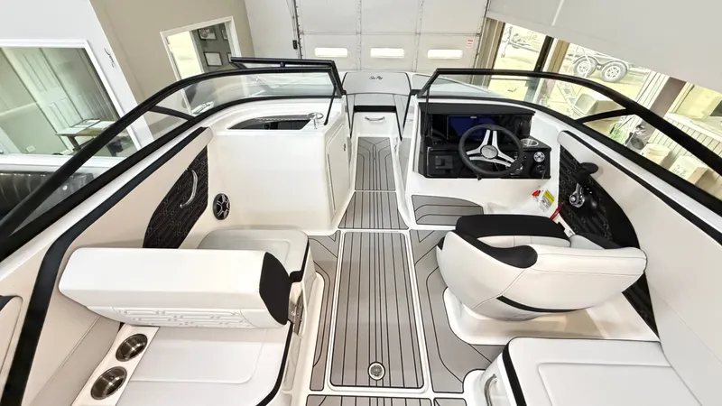 Slide: The Image of Interior of a 2026 Sea Ray SPX 210 boat with modern seating and steering wheel. - 29