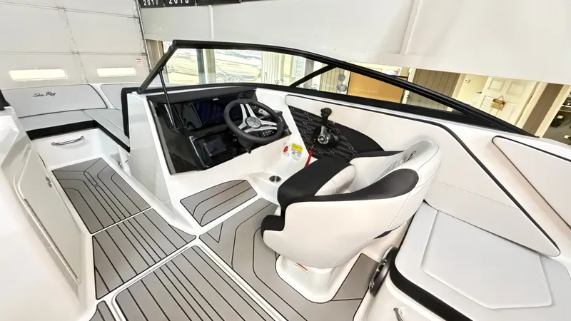 Slide: The Image of The image shows the cockpit of a 2026 Sea Ray SPX 210 boat with modern seating and controls. - 35