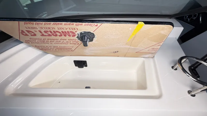 Slide: The Image of An open storage compartment on a 2026 Sea Ray SPX 210 boat. - 47