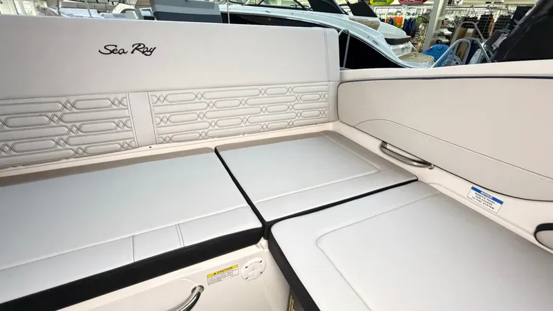 Slide: The Image of The 2026 Sea Ray SPX 210 features a sleek, cushioned seating area with a modern design. - 20