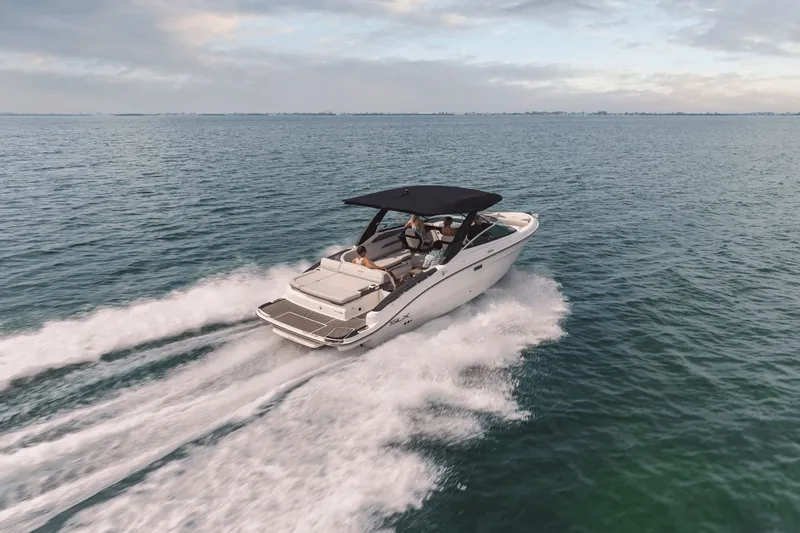 Slide: The Image of A 2027 Sea Ray SLX 280 speeds across the water, featuring a black canopy. - 39