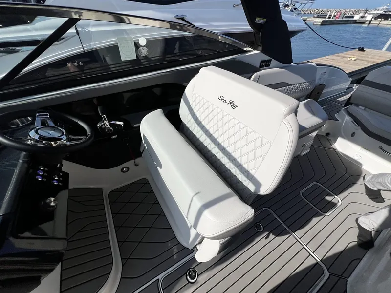 Slide: The Image of The image shows the cockpit of a Sea Ray SLX 280 boat with white upholstered seats. - 9