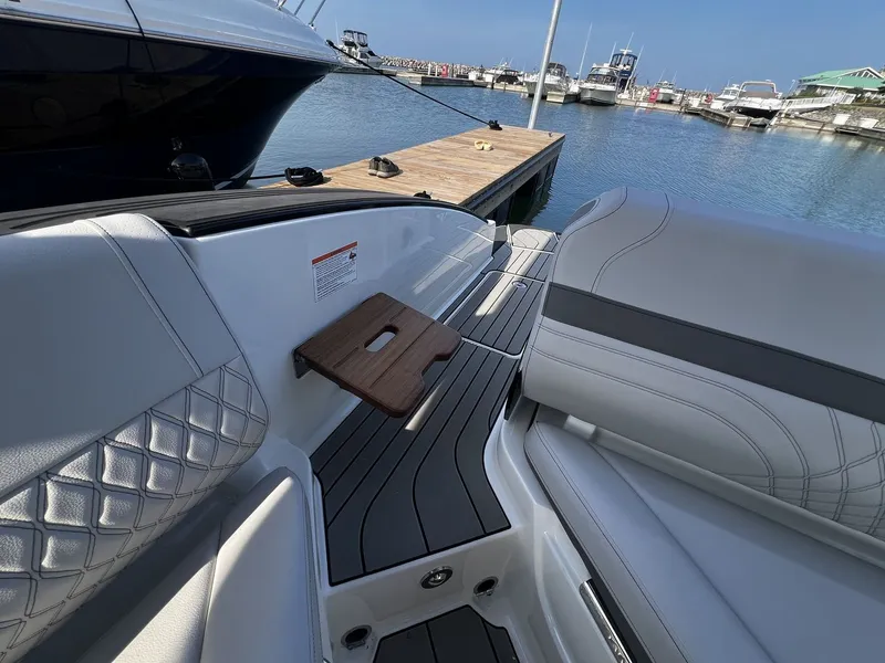 Slide: The Image of The image shows the elegant interior of a Sea Ray SLX 280 with luxurious seating and a wooden table. - 19