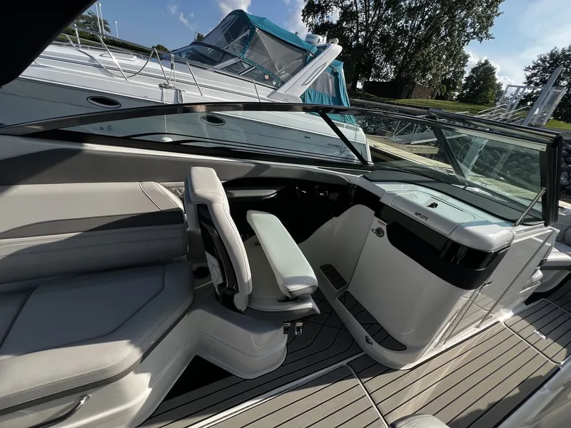 Slide: The Image of The image shows the cockpit of a Sea Ray SLX 280 boat with modern seating and controls. - 28