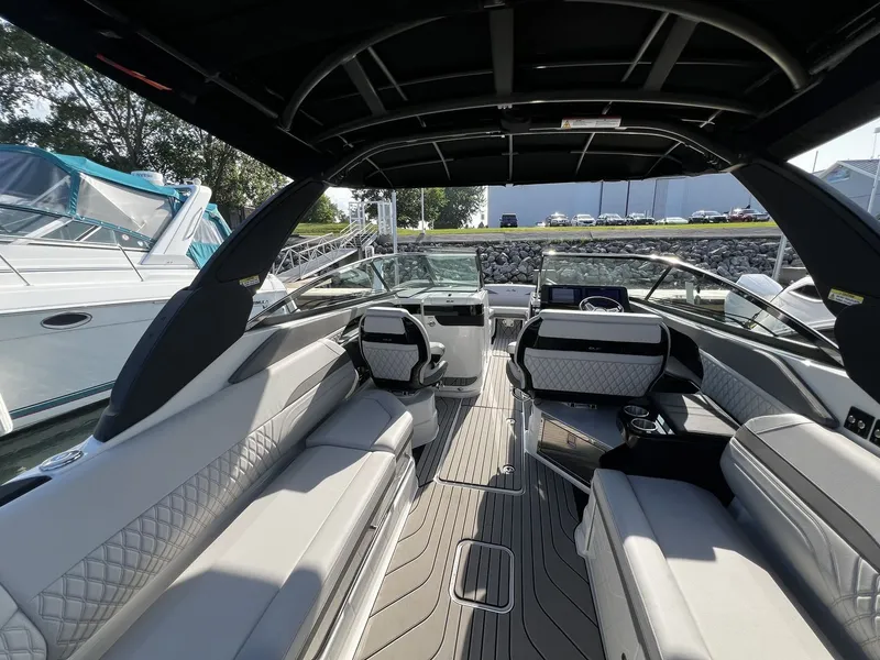 Slide: The Image of Interior view of a modern Sea Ray SLX 280 with sleek seating and a stylish cockpit. - 25