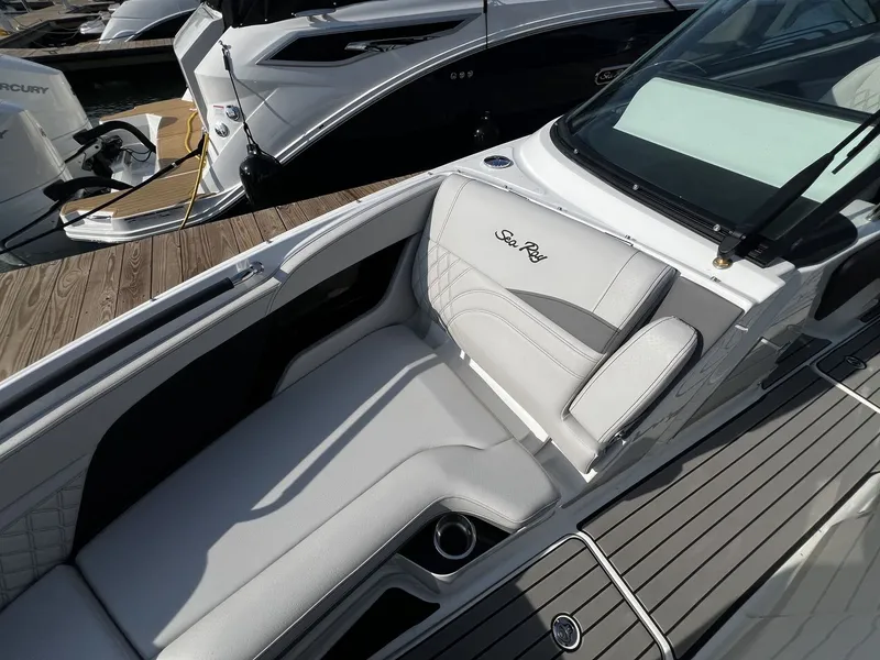 Slide: The Image of The image shows the cockpit of a Sea Ray SLX 280 boat with sleek white upholstery. - 16