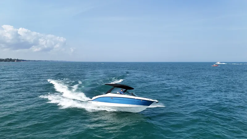 Slide: The Image of A 2027 Sea Ray SLX 280 speeds across open water under a clear sky. - 6
