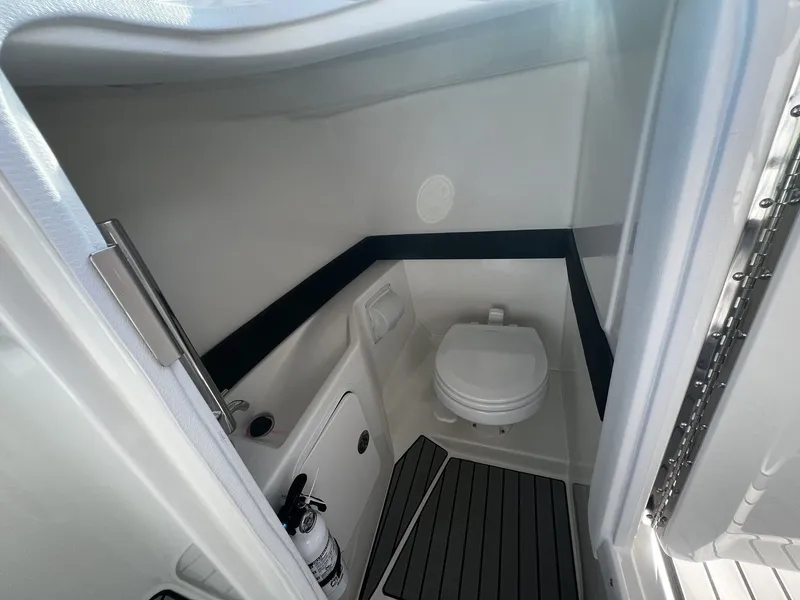 Slide: The Image of The image shows a compact boat bathroom with a toilet, sink, and fire extinguisher. - 11