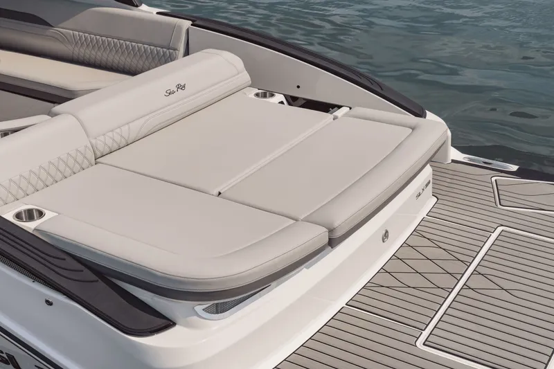 Slide: The Image of The image shows the stern of a Sea Ray SLX 280 with a large sun pad and gray upholstery. - 16