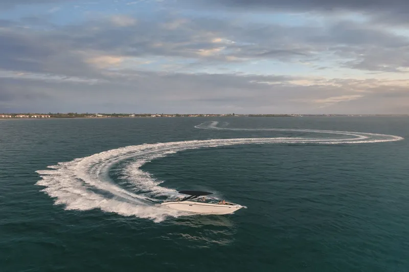 Slide: The Image of A 2027 Sea Ray SLX 280 speeds across open water, leaving a curved wake behind. - 47
