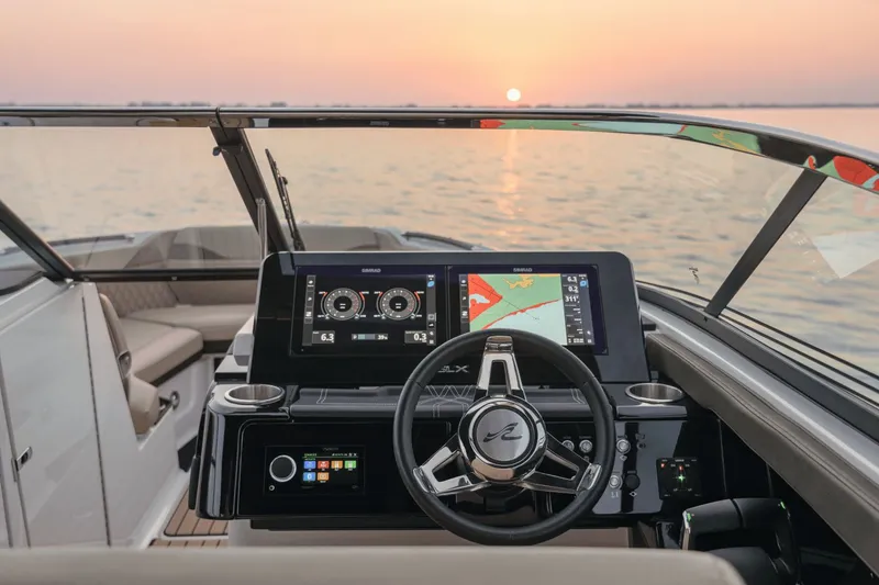 Slide: The Image of The image shows the cockpit of a 2027 Sea Ray SLX 280 with modern instruments and a sunset in the background. - 9