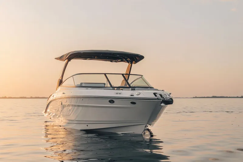 Slide: The Image of A sleek 2027 Sea Ray SLX 280 boat on calm water at sunset. - 41