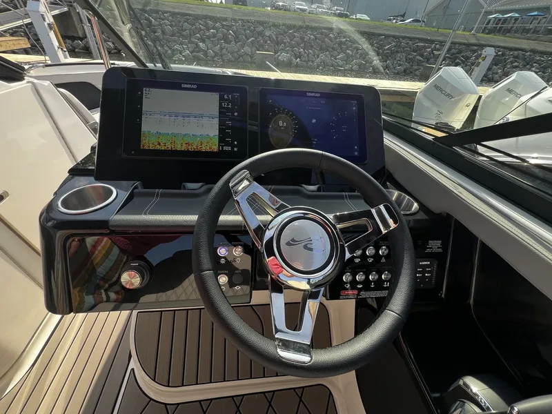 Slide: The Image of The 2027 Sea Ray SLX 280 cockpit features a modern steering wheel and two large displays. - 8