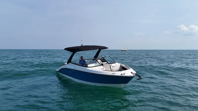 Slide: The Image of A 2027 Sea Ray SLX 280 cruising on calm waters with a black sunshade. - 3