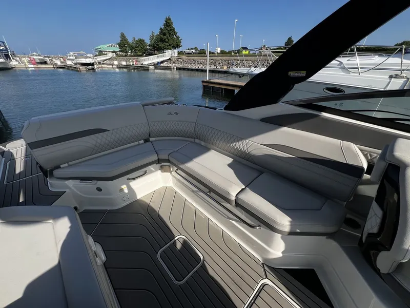 Slide: The Image of The image shows the sleek cockpit of a 2027 Sea Ray SLX 280 at the marina. - 27