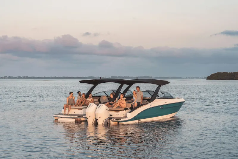 Slide: The Image of A group of people relaxes on a Sea Ray SLX 280 boat on calm waters. - 31
