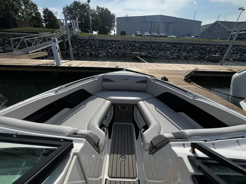 Slide: The Image of The image shows the cockpit of a Sea Ray SLX 280 boat with gray upholstery and a wooden floor. - 12