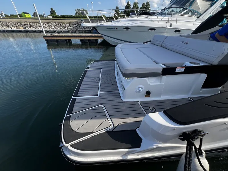 Slide: The Image of The image shows the stern of a 2027 Sea Ray SLX 280 boat docked at a marina. - 20
