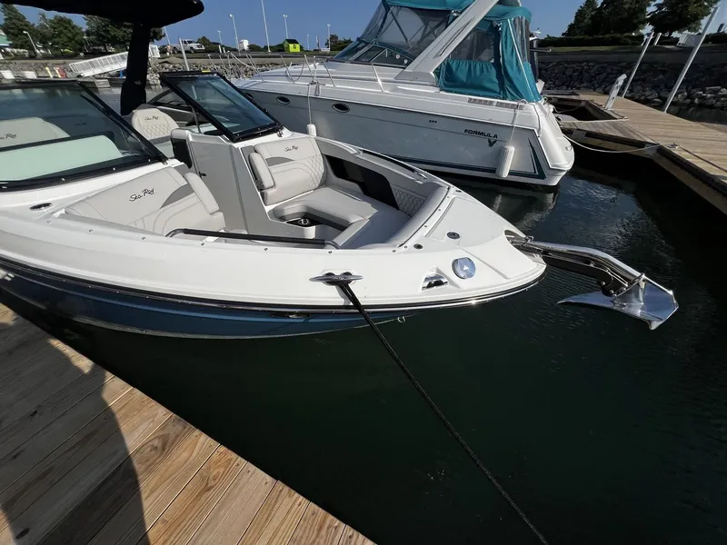 Slide: The Image of 2027 Sea Ray SLX 280 docked, featuring sleek design and spacious deck. - 23