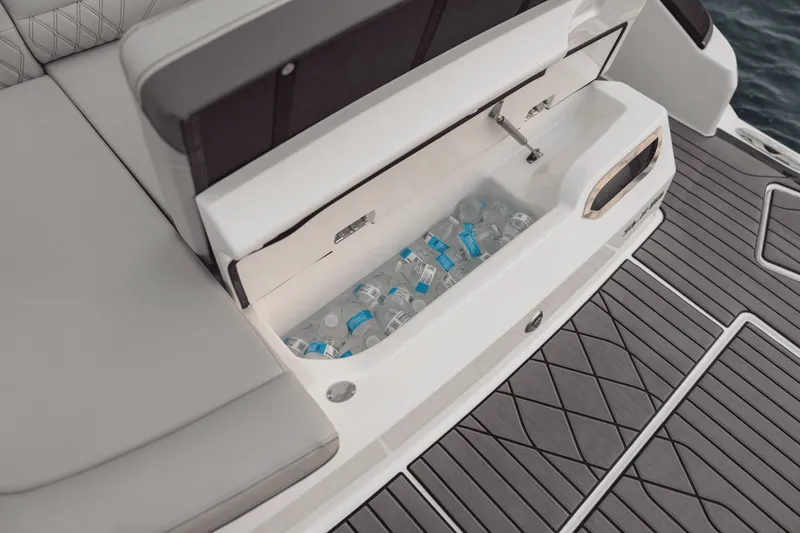Slide: The Image of The image shows the storage compartment of a Sea Ray SLX 280 boat filled with water bottles. - 17