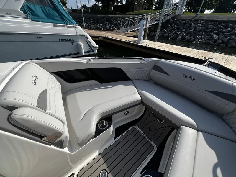 Slide: The Image of The image shows the cockpit of a Sea Ray SLX 280 boat with sleek, cushioned seating. - 14