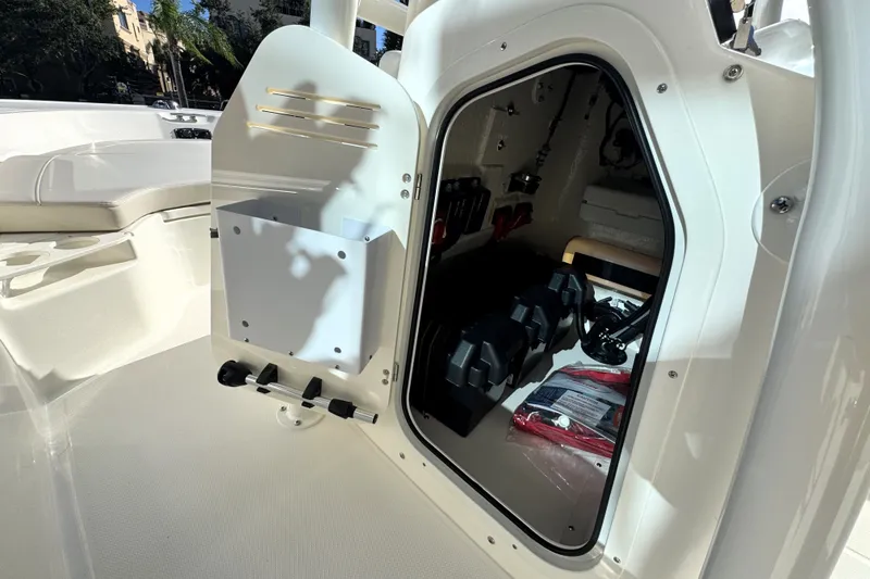 Slide: The Image of A storage compartment on a Boston Whaler 190 Montauk boat, containing various equipment. - 20