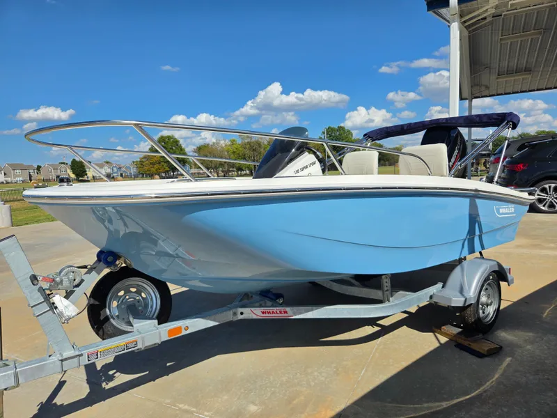 Slide: The Image of A blue 2027 Boston Whaler 130 Super Sport on a trailer, ready for adventure. - 4
