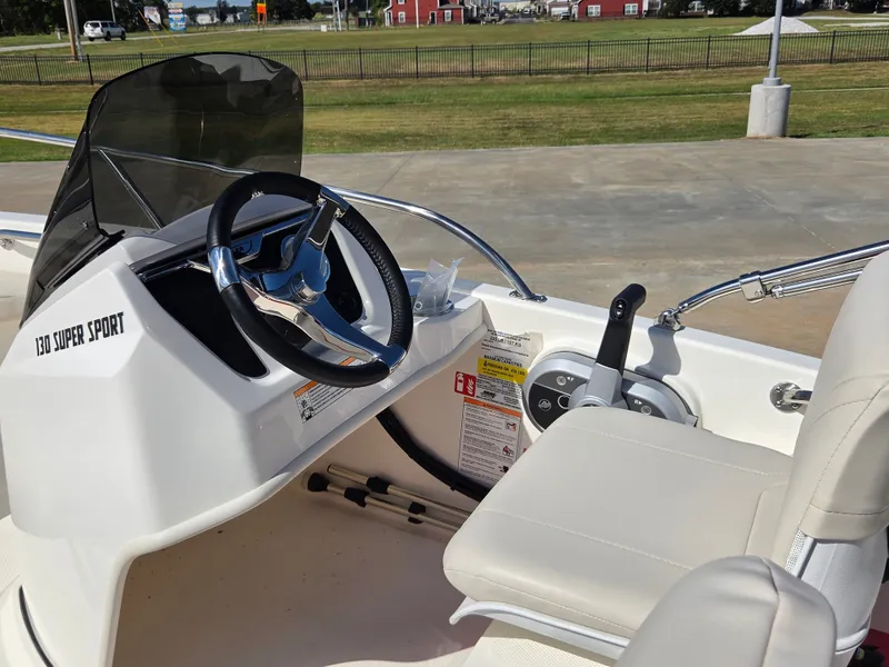 Slide: The Image of The image shows the cockpit of a 2027 Boston Whaler 130 Super Sport with a modern steering wheel. - 10