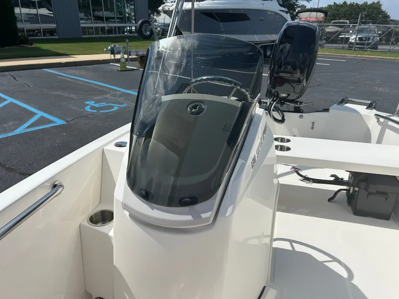 Slide: The Image of The image shows a modern Boston Whaler 130 Super Sport boat with a sleek helm station. - 11