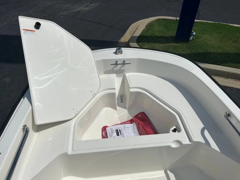 Slide: The Image of The image shows the bow of a Boston Whaler 130 Super Sport with an open storage compartment. - 10
