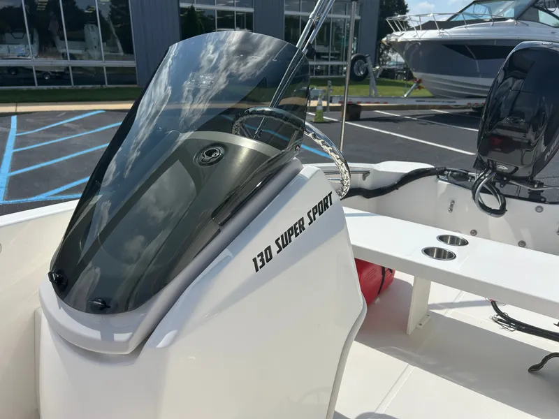 Slide: The Image of The image shows a 2027 Boston Whaler 130 Super Sport boat with a sleek design. - 13